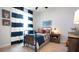 Cozy bedroom with rustic bed and navy striped curtains at 211 Bilge Rd, Ridgeville, SC 29472