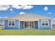 The sliding glass doors shown on the rear of the property lead to a covered outdoor living space at 211 Bilge Rd, Ridgeville, SC 29472