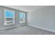 Neutral carpet and pale blue walls with outside views from two bedroom windows at 213 Bilge Rd, Ridgeville, SC 29472
