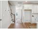 Bright entryway with hardwood floors, staircase, and view of kitchen at 233 Abercom Place Dr, Moncks Corner, SC 29461
