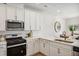 Modern kitchen with white cabinets and a built-in microwave at 233 Abercom Place Dr, Moncks Corner, SC 29461