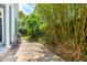 Landscaped backyard with brick pathway, fountain, and lush greenery at 27 Chapel St, Charleston, SC 29403