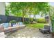Relaxing flagstone patio with wicker furniture and a lush, private garden at 27 Chapel St, Charleston, SC 29403
