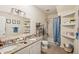 Bathroom with granite countertop, double sinks, and a shower/tub combo at 27 Chapel St, Charleston, SC 29403