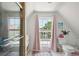 Bright bathroom with shower, window, and patterned rug at 27 Chapel St, Charleston, SC 29403