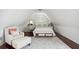 Charming attic bedroom with a queen-size bed and hardwood floors at 27 Chapel St, Charleston, SC 29403