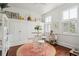 Small breakfast nook with round table and white stools at 27 Chapel St, Charleston, SC 29403