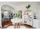 Bright dining area with white table and chairs, kitchen view at 27 Chapel St, Charleston, SC 29403