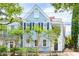 Beautiful light blue two-story home with lush landscaping at 27 Chapel St, Charleston, SC 29403