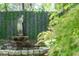 Statuesque fountain with lush greenery, creating a serene garden oasis at 27 Chapel St, Charleston, SC 29403
