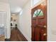 Long hallway with hardwood floors and a wooden door at 27 Chapel St, Charleston, SC 29403