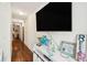Hallway with hardwood floors, a mounted TV, and decor at 27 Chapel St, Charleston, SC 29403