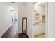 Long hallway with dark hardwood floors and a full-length mirror at 27 Chapel St, Charleston, SC 29403