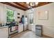 Kitchen with white cabinets, stainless steel appliances, and backyard access at 27 Chapel St, Charleston, SC 29403