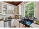 Kitchen with white cabinets, stainless steel appliances, and wood beams at 27 Chapel St, Charleston, SC 29403