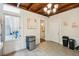 Kitchen with white cabinets, wood beams, and backyard access at 27 Chapel St, Charleston, SC 29403