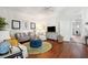 Living area with hardwood floors, comfy seating, and a view into another room at 27 Chapel St, Charleston, SC 29403