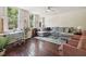 Living room featuring hardwood floors, gray sectional sofa and a workspace at 27 Chapel St, Charleston, SC 29403