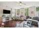 Living room with hardwood floors, gray sectional sofa and a workspace at 27 Chapel St, Charleston, SC 29403