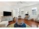 Living room featuring hardwood floors, a TV, and comfortable seating at 27 Chapel St, Charleston, SC 29403