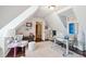 Bright attic office features a workspace, seating area, and hardwood floors at 27 Chapel St, Charleston, SC 29403