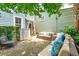 Stone patio with comfortable seating area and lush landscaping at 27 Chapel St, Charleston, SC 29403