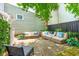 Stone patio with comfortable seating area and lush landscaping at 27 Chapel St, Charleston, SC 29403