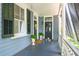 Covered porch with potted plants and a wreath at 27 Chapel St, Charleston, SC 29403