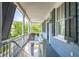 Upstairs porch with white railings, gray siding and shutters at 27 Chapel St, Charleston, SC 29403