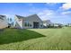 Large backyard with grassy area and a home with screened porch at 274 Tupelo Lake Dr, Summerville, SC 29486