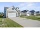 Tan colored two-story home with a white garage door and American Flag at 274 Tupelo Lake Dr, Summerville, SC 29486