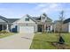 Two-story craftsman style home with a two car garage and landscaped lawn at 274 Tupelo Lake Dr, Summerville, SC 29486