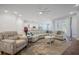 Spacious living room featuring a sectional sofa, large windows, and hardwood floors at 274 Tupelo Lake Dr, Summerville, SC 29486