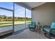 Relaxing screened porch with wicker furniture and view of backyard at 274 Tupelo Lake Dr, Summerville, SC 29486
