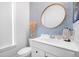 Stylish bathroom with a modern vanity, patterned wallpaper, and a large mirror at 2742 Mcfadden Way, Johns Island, SC 29455