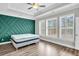 Spacious bedroom with green accent wall and hardwood floors at 327 Great Lawn Dr, Summerville, SC 29486