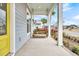 Porch with wooden swing, overlooking the neighborhood at 327 Great Lawn Dr, Summerville, SC 29486