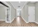 Long hallway with hardwood floors and french doors at 327 Great Lawn Dr, Summerville, SC 29486