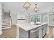 Open concept kitchen with island and stairs visible at 327 Great Lawn Dr, Summerville, SC 29486
