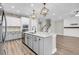 Open concept kitchen with island and gray cabinets at 327 Great Lawn Dr, Summerville, SC 29486