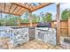 Stone outdoor kitchen with stainless steel appliances at 327 Great Lawn Dr, Summerville, SC 29486