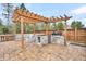 Outdoor kitchen with built-in grill, stone counters, and pergola at 327 Great Lawn Dr, Summerville, SC 29486