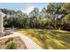 Landscaped backyard with a stone walkway leading to a pool at 3365 Westphal Dr, Johns Island, SC 29455