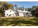 Large backyard with a home featuring a metal roof and screened porch at 3365 Westphal Dr, Johns Island, SC 29455
