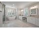 Spa-like bathroom with soaking tub, double vanities, and marble floors at 3365 Westphal Dr, Johns Island, SC 29455