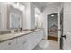 Double vanity bathroom with gray counters, white cabinets, and a view into a bedroom at 3365 Westphal Dr, Johns Island, SC 29455