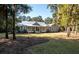 Gray farmhouse with metal roof, large porch, and landscaped yard at 3365 Westphal Dr, Johns Island, SC 29455