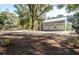 Three-car garage with metal roof and spacious gravel driveway at 3365 Westphal Dr, Johns Island, SC 29455