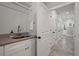 Laundry room with sink, white cabinets, and access to additional storage at 3365 Westphal Dr, Johns Island, SC 29455