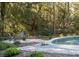 Round pool with stone patio and fire pit area at 3365 Westphal Dr, Johns Island, SC 29455
